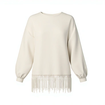 A blouse, featuring intricate fringe details along the hem and sleeves. The fabric has a soft, flowy texture in a light cream color. The blouse has a relaxed fit, with slightly oversized sleeves that gather at the wrists. The fringe hangs elegantly, adding movement and texture to the garment. It is showcased against a simple, neutral background to emphasize the design.