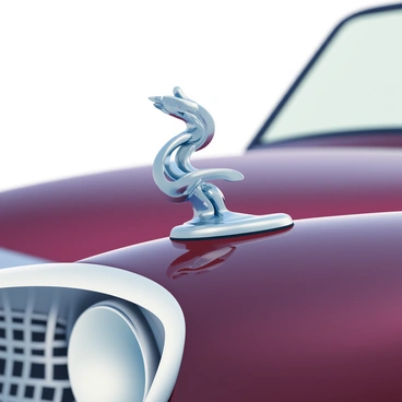 A 3D close-up of an elegant hood ornament on a classic car is featured prominently in the image. The hood ornament is intricately designed, showcasing a graceful figure that exudes sophistication. The ornament's surface is polished and reflective, capturing the surrounding light and details of the car's shiny exterior. The classic car itself, painted in a deep burgundy hue, has smooth curves and chrome accents that complement the ornate design of the hood ornament. The background is softly blurred, focusing attention on the exquisite craftsmanship of the ornament and the luxurious appeal of the vehicle.