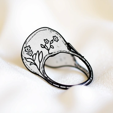 A close-up of a vintage ring with an intricate floral design