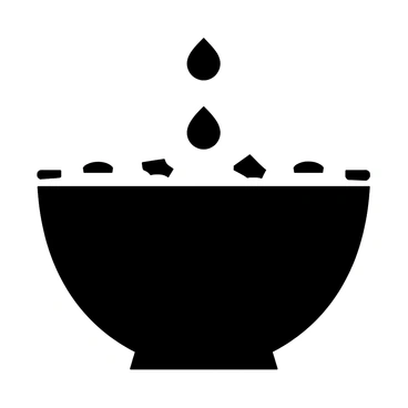 Ripples forming in a bowl of baptismal water with a soft reflection of light glistening on the surface.