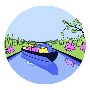 A barge with a dark blue hull slowly navigates through a narrow canal. The water reflects the surrounding greenery, which includes tall grass and vibrant shrubs on either side. Overhead, there are leafy branches extending towards the water. The barge is loaded with colorful crates, creating a contrast against the natural backdrop. The scene captures the peacefulness of the canal, with clear blue skies above.