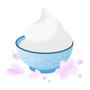 A scoop of sake-flavored ice cream is placed in a decorative ceramic bowl adorned with intricate patterns. The ice cream has a creamy texture with a light, subtle sheen. The bowl features a gradient of pastel colors, blending soft pinks and blues. Surrounding the bowl is a scattering of delicate cherry blossom petals, adding a touch of nature. The scene is softly lit, enhancing the colors and textures of the ice cream and bowl, creating a visually appealing arrangement.