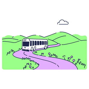 A white bus is traveling down a winding countryside road. The road is flanked by expansive fields on both sides. In the foreground, there are patches of green grass and wildflowers scattered along the edges. The bus is moving forward with its windows reflecting the scenery. In the background, rolling hills can be seen, partially covered with green vegetation. The sky above is clear, allowing a few puffy clouds to drift gently.