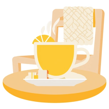 A steaming cup of yellow lemon tea with a slice of lemon resting on the rim. The cup is placed on a round, wooden table that has a warm, inviting finish. A small white saucer sits beneath the cup. In the background, a soft knitted blanket is draped over a chair, adding to the cozy atmosphere. A couple of sugar cubes are positioned next to the cup on the table.