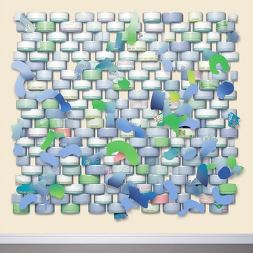 A large mural composed entirely of recycled tuna cans fills the wall. The cans are arranged in various colors, including shades of silver, blue, and green, creating a vibrant display. The design features abstract shapes and flowing patterns, showcasing the creative use of texture and materials. Some cans are flattened to form a smooth surface, while others retain their original cylindrical form. The background of the mural is a contrasting light beige wall, emphasizing the colorful arrangement of the tuna cans. The scene captures the details of the cans, including labels and the reflections of light on the metallic surfaces.