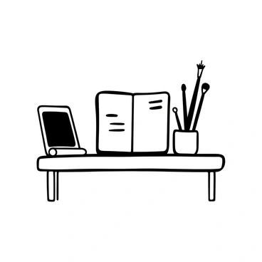 A minimalist desk with a single sketchbook, a pot of brushes, and a laptop
