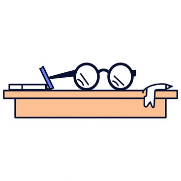 A pair of glasses with one broken lens sitting on a desk