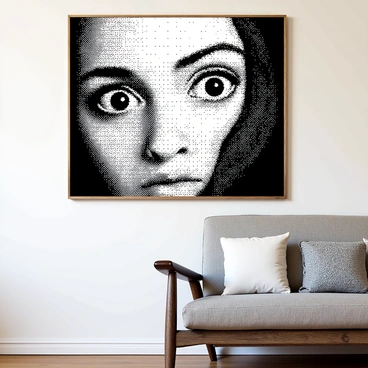 An artwork is displayed prominently on a wall. The painting features large, detailed eyes that appear to be gazing directly at the viewer. The eyes are set against a contrasting background, creating a sense of depth. The expression in the eyes is intense, evoking a feeling of connection and engagement. The overall composition draws the viewer in, making it seem as though the eyes shift in their gaze as the viewer moves around the room.