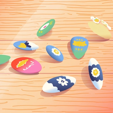 A collection of colorful guitar picks is scattered across a textured wooden table. Each pick features unique designs, including geometric patterns, floral motifs, and vibrant colors like red, blue, and yellow. The picks are arranged randomly, some lying flat while others are tilted at various angles, catching the light. The wood of the table displays natural grain patterns and warm tones, providing a contrasting backdrop for the bright picks.