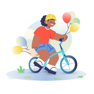 A child with light brown skin and curly hair is riding a small, bright blue bike. The bike has colorful balloons tied to the handlebars, including red, yellow, and green balloons that are bouncing gently in the breeze. The child is wearing a red t-shirt and denim shorts, along with a yellow helmet for safety. The ground beneath them is a light gray pavement, with a few patches of green grass peeking through. In the background, there are hints of a sunny day with a clear blue sky.