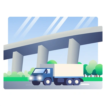 A large, dark blue truck is driving under a massive gray highway overpass. The truck has a white cargo container and its headlights are on, illuminating the area ahead. The overpass features thick concrete pillars and a wide, arching structure that spans above. Sunlight filters through, casting shadows on the ground below. In the background, there are green trees lining the roadside, and a clear blue sky above.