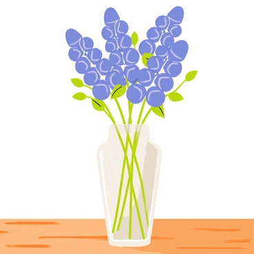A clear glass vase filled with a bouquet of bluebonnets stands prominently on a wooden table. The bluebonnets have vibrant blue petals with delicate green leaves. The wooden table has a rich, warm tone with visible grain patterns. Soft light reflects off the glass vase, creating subtle highlights and shadows. The arrangement of bluebonnets is natural, with some stems slightly curved and others standing tall.