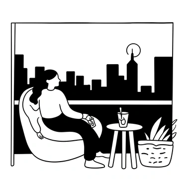 A woman with long hair is seated in a comfortable chair on her balcony. She is holding a glass drink in one hand while looking out towards the city skyline. The sky is filled with the fading light of sunset, casting distinct shapes of buildings in silhouette against the horizon. There are potted plants on the balcony railing, adding greenery to the scene, and a small table beside her holds a second drink.