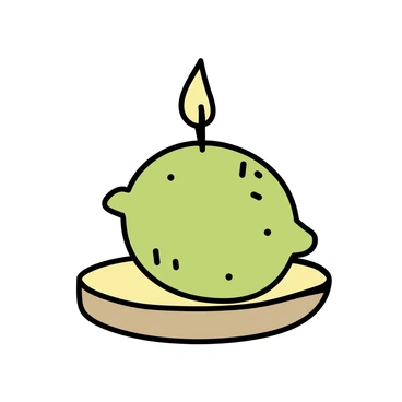 A decorative candle in the shape of a lime, featuring a vibrant green exterior with a textured surface that mimics the appearance of a real lime. The candle is small and round, placed on a simple wooden table. The wick is centered on top, ready to be lit. The candle emits a faint glow, suggesting a warm, inviting ambiance.