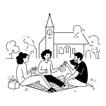 A group of four friends sitting on a checkered picnic blanket spread out on the grass. One friend, a woman with long hair, is holding a sandwich and laughing, while another woman with curly hair is pouring drinks from a thermos. A man with a beard is reclining on the blanket, resting on one elbow and engaging in the conversation, while another man with short hair is sitting cross-legged, smiling. In the background, there is a church building with tall steeple and arched windows, surrounded by trees and blooming flowers. The scene conveys a sense of community and anticipation for the upcoming event.