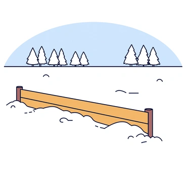 A snow-covered landscape with a smooth white blanket of snow covering the ground. In the foreground, there is a wooden fence made of horizontal planks, with a rustic design, leading straight into the distance. The fence is partially buried in snow, with small snowdrifts forming along its base. In the background, a line of snow-laden trees rises against a clear blue sky.