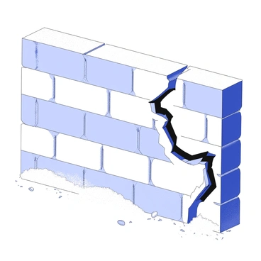 A brick wall is prominently displayed, featuring a rough, textured surface made up of various rectangular bricks. A jagged crack runs diagonally through several bricks, creating an irregular line that disrupts the otherwise uniform pattern of the wall. The edges of the crack are uneven, revealing the inner structure behind the bricks. Dust and small debris are scattered around the base of the wall, emphasizing the wear and age of the structure. The light casts soft shadows, enhancing the depth of the crack and the surface details of the bricks.