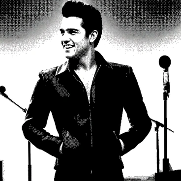 Elvis Presley is standing confidently, wearing a fitted black leather jacket that accentuates his silhouette. His hair is styled in his signature pompadour, showcasing a polished, classic look. He has a charismatic expression, with a slight smile on his lips, as he gazes off to the side. In the background, there are microphone stands and stage lights, indicating a performance setting. His stance is dynamic, suggesting he is about to step onto a stage for a significant comeback special.