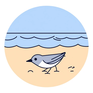 A mockingbird with gray and white feathers is exploring a sandy beach. The bird stands on a patch of light tan sand, curiously pecking at the ground. In the background, gentle waves are rolling in, creating a rhythmic pattern as they reach the shore. The sky above is clear and bright, adding a vibrant blue hue to the scene.