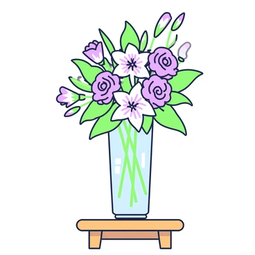 An elegant floral arrangement in a glass vase on a simple wooden table.