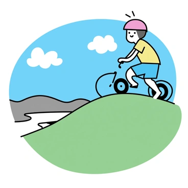 A cartoon character with a cheerful expression is reaching the top of a green hill on a small blue bike. The character is wearing a red helmet and a yellow T-shirt with blue shorts. At the peak, the character is looking out over a wide valley with a bright blue sky above. The hill is covered in soft grass, and a few fluffy white clouds are scattered in the sky. The character's bike is positioned at an angle, emphasizing the hill's slope. In the distance, there are rolling hills and a winding river visible below.