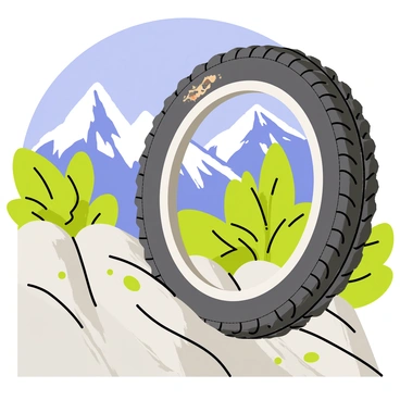 A close-up of a rugged mountain bike tire maneuvering over uneven and jagged rocks. The tire shows deep treads designed for traction, with small pebbles and dirt clinging to its surface. In the background, there is a stunning view of tall, snow-capped mountains under a clear blue sky. Lush green vegetation can be seen framing the rocky terrain, enhancing the natural beauty of the landscape.