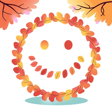 A large circle made from various autumn leaves is arranged on the ground in a park. The leaves exhibit shades of orange, red, and yellow, creating a vibrant representation of a smiley face. Within the circle of leaves, two smaller circular formations of leaves represent the eyes and a curved arrangement of leaves forms the smile. The background features trees with colorful foliage and a grassy area surrounding the leaf arrangement. Soft sunlight filters through the branches, enhancing the warm colors of the autumn scene.