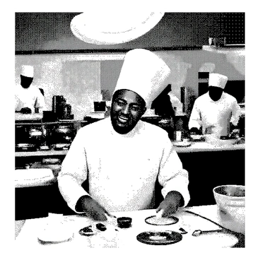 A man with a round face and a broad smile is illustrated as "Vadivelu," dressed in a traditional chef's uniform, complete with a white chef's hat. He is in the center of a bustling kitchen, with various kitchen utensils and ingredients scattered around him. He is in the act of tossing a pizza dough high into the air, showcasing his skill. The kitchen is filled with chefs and kitchen staff, each engaged in their tasks, such as chopping vegetables and preparing sauces. The environment is lively, with pots and pans steaming on the stove and the aroma of food present.