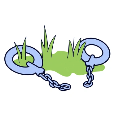 A pair of broken shackles lying on the ground. The shackles are metallic with a weathered and rusty surface. Green grass is growing around them, with a few blades poking through the gaps in the chains. The ground is uneven, adding a natural texture to the scene.
