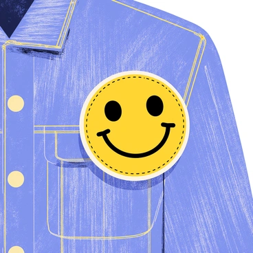 A denim jacket with a textured blue fabric, featuring a round smiley face patch stitched onto the left chest area. The smiley face has a bright yellow color with two black dotted eyes and a wide black smile. The edges of the patch show intricate stitching details, blending with the jacket's fabric texture. The background of the jacket exhibits slight wear, adding character to the clothing piece. The overall composition highlights the playful design of the patch against the classic denim backdrop.