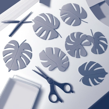 A collection of cut-out paper monstera leaves arranged meticulously on a wooden surface. Each leaf displays intricate details, showcasing the characteristic splits and holes found in monstera foliage. Some leaves are overlapping slightly, creating a layered effect, while others are positioned at varying angles. Scissors and a small stack of unused paper can be seen nearby, indicating the crafting process. The background is softly blurred to emphasize the handmade quality of the craft project.