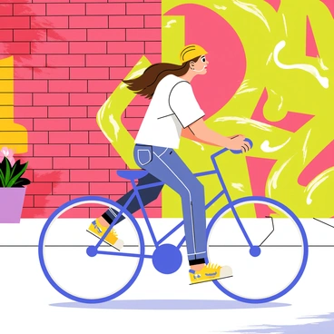 A woman riding a blue bicycle is cycling past vibrant urban street art murals. The murals feature a mix of bold colors, including reds, yellows, and greens, with abstract designs and intricate patterns. The background consists of brick walls adorned with various artistic styles, showcasing large graffiti-style characters and dynamic shapes. The woman has long brown hair flowing behind her, wearing a bright yellow helmet and a casual white t-shirt. Sunlight casts shadows on the pavement, enhancing the lively atmosphere of the scene.