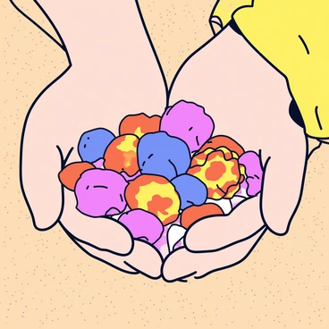 A close-up view of a child's hands gently cradling a collection of colorful seashells. The shells vary in hues of pink, orange, and blue, each displaying unique patterns and textures. The child's hands are small and slightly sandy, with tiny fingers curled around the shells. In the background, fine grains of beige sand are visible, creating a warm beach setting. Sunlight reflects off the surfaces of the shells, adding a soft glow to the scene.