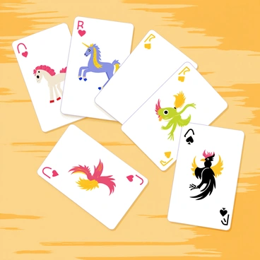 A set of playing cards laid out on a wooden table. Each card features a unique design representing a mythical creature, with the hearts symbol displaying a graceful unicorn, the diamonds symbol showcasing a fierce dragon, the clubs symbol illustrating a powerful griffin, and the spades symbol depicting a wise phoenix. The cards have intricate borders and vibrant colors, enhancing the enchanting appearance of the mythical creatures.
