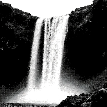 A waterfall of molten lava is cascading down rocky cliffs. The lava flows in bright, glowing streams, creating a stark contrast against the dark, jagged rocks of the cliffside. The surrounding landscape is rugged and barren, with sharp edges and crevices visible on the cliffs. The scene captures the dynamic motion of the lava as it tumbles over the edges, creating splashes and drips that flow smoothly. The air appears thick with heat, shimmering above the flowing lava.