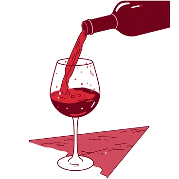 Wine being poured into a glass with droplets capturing the light