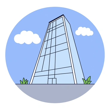 A view from the base of a skyscraper looking upwards. The skyscraper towers high above, with large glass windows reflecting the sky. The perspective emphasizes the height of the building, creating a sense of scale. The sky is clear blue with a few fluffy white clouds in the background. The surrounding ground is made of grey concrete, with small plants growing near the base of the skyscraper.