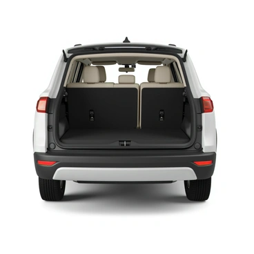 The interior of a white SUV featuring a spacious cargo area. The seats are folded down flat, creating a large and open space. The cargo area is lined with a durable floor mat, showcasing a smooth surface. The sides of the cargo area are designed with protective panels, and there are compartments for storing smaller items. The rear of the SUV has an adjustable cargo cover that can be pulled over to conceal the contents. Natural light filters in through the rear window, illuminating the interior space.