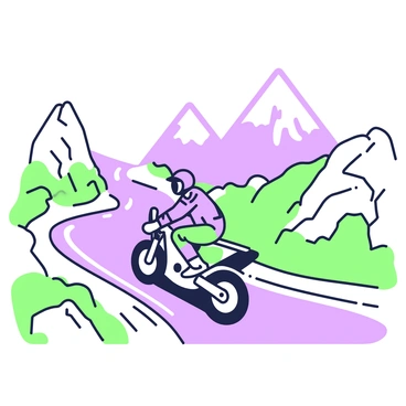 A motorcyclist is riding a motorcycle on a winding mountain road. The rider is wearing a helmet and protective gear, including gloves and a jacket. The motorcycle is in motion, with the rider leaning slightly forward as they apply the brakes. The road twists sharply to the left, bordered by rocky cliffs and patches of grass. In the background, tall mountains rise majestically, partially shrouded in mist. The scene captures the sense of speed and control as the motorcyclist navigates the challenging terrain.