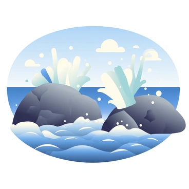 Waves are crashing against rugged, dark rocks at the shore, sending large sprays of water into the air. The splashes are captured in mid-air, glistening in the sunlight. The sea is a deep blue, contrasting with the gray rocks, while white foam forms at the crest of the waves. In the background, the horizon stretches out to meet a clear blue sky with a few wispy clouds. The scene conveys a sense of movement and energy as the ocean relentlessly meets the land.