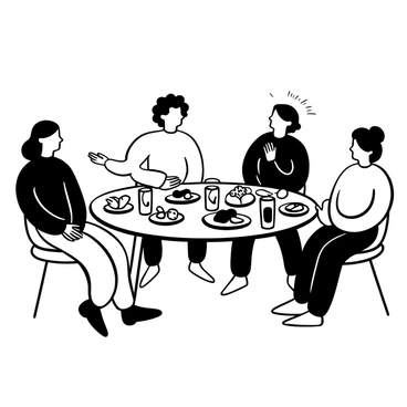 A group of friends laughing and sharing stories around a table filled with snacks and drinks.