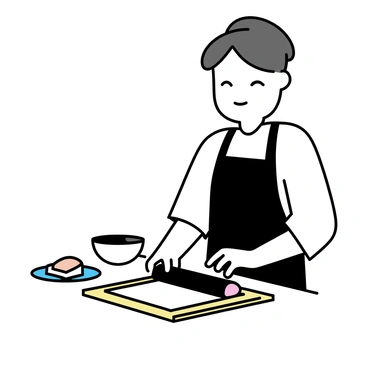 A sushi chef, wearing a white uniform and a black apron, is focused on preparing sushi. He is rolling a sheet of seaweed filled with rice and various ingredients on a wooden sushi mat. His hands are skillfully maneuvering the roll, ensuring a tight fit. A small bowl of soy sauce and a plate of sliced sushi rolls are placed on the table nearby. The chef's expression shows concentration as he works in a well-lit kitchen setting.