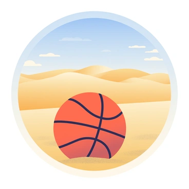 A basketball with an orange surface and black stripes is resting on the sandy ground. The sand has a coarse texture and is illuminated by bright sunlight, creating a warm, golden hue. In the background, a vast desert landscape stretches out, with rolling sand dunes that rise and fall gently. The sky above is clear and blue, with a few wispy clouds scattered across it. The scene conveys a sense of openness and the quiet solitude of the desert environment.