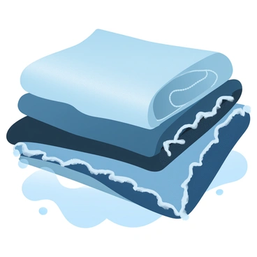 A close-up view of various denim fabrics arranged neatly on a table. The denim displays a range of textures, including smooth, distressed, and frayed finishes. Each piece of fabric is folded or draped to emphasize its unique characteristics. The colors of the denim include light blue, dark navy, and shades of grey, blending harmoniously together. Soft natural light casts gentle shadows, highlighting the weaves and patterns within the fabrics.