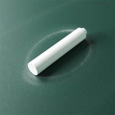 A white piece of chalk with a smooth surface, resting horizontally on a dark green chalkboard. The chalk is positioned near the edge of the chalkboard, suggesting it is on the verge of rolling off. Fine dust from the chalk is scattered around, emphasizing its use. The texture of the chalkboard is visible, with a faint sheen indicating it has been recently written on. The overall scene hints at static friction, as the chalk remains in place despite its precarious position.
