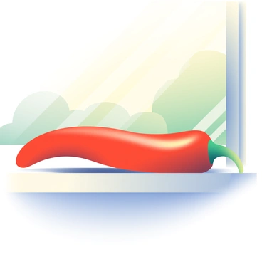 A single bright red chili pepper is resting on a sunlit windowsill. The sunlight is streaming in from behind, highlighting the glossy surface of the pepper. The chili pepper is elongated with a green stem at the top. It casts a long shadow onto the smooth surface of the windowsill, which has a light wood texture. The background shows a hint of greenery from outside the window, softly blurred by the sunlight.