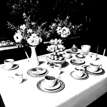 An outdoor tea party setup is arranged on a white tablecloth spread over a rustic wooden table. Delicate china teacups and saucers are elegantly placed on the table, showcasing intricate patterns and designs. An assortment of pastries, including small cakes and tarts, are artfully displayed on a tiered stand. Fresh floral arrangements in small vases are scattered across the table, featuring a variety of blooms that add charm to the scene. Sunlight filters through nearby trees, casting soft shadows on the table and creating a warm atmosphere for the gathering.