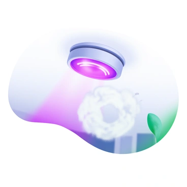 A smoke detector is mounted on a white ceiling, with "red lights" flashing brightly. Below the detector, a light haze of gray smoke is visible, swirling gently around. The smoke has a soft texture, creating a clear indication of smoke presence. The background is kept simple and unobtrusive to emphasize the smoke detector and the smoke surrounding it.