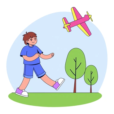 A child with short brown hair is joyfully flying a remote-controlled airplane. The airplane is brightly colored with red and yellow wings. The child is standing on green grass in a park, wearing a blue t-shirt and denim shorts. In the background, there are a few trees with green leaves and a clear blue sky. The child's expression is focused and happy as they control the airplane soaring above.