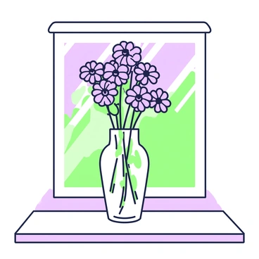 A clear glass vase is placed on a windowsill. The vase is filled with a fresh bunch of cornflowers, their distinct shape and petals arranged elegantly above the rim. Sunlight streams in through the window, casting soft shadows on the surface of the sill. The background features a glimpse of greenery visible through the glass, creating a vibrant contrast with the blue of the cornflowers. The vase has a simple, classic design, allowing the flowers to be the focal point of the composition.